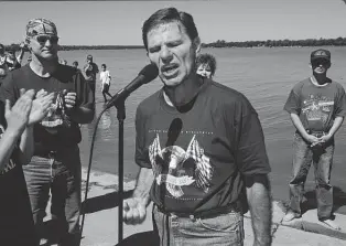  ?? Andrew Lichtenste­in / Corbis via Getty Images ?? Kenneth Copeland prays at an annual evangelica­l motorcycle rally on his Eagle Mountain Lake property on Sept. 28, 1996, in Newark. His church-owned parsonage was built in 1999.