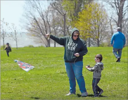  ?? SARAH GORDON/THE DAY ?? Audrey Dumais of Enfield helps her foster son Danny Cyr, 4 years old, fly a kite at Harkness Memorial State Park in Waterford on Sunday. The family spent Mother’s Day at the park to get fresh air. “It’s a little too windy for kite flying but we’ll get it up for a few seconds,” Dumais said.