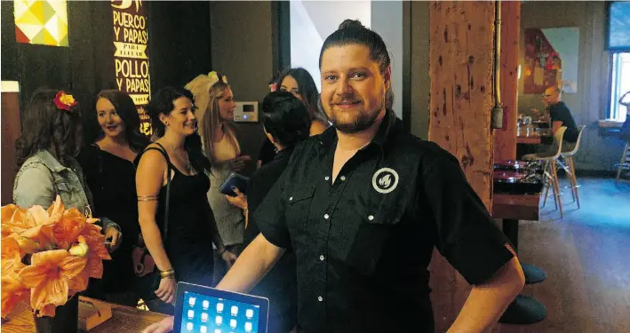  ?? LARRY WONG/ EDMONTON JOURNAL ?? Nick Martin, general manager at Rostizado, says the NoWait app makes managing long lineups during the dinner rush a little easier.