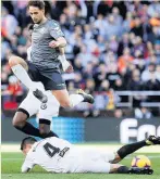  ??  ?? REAL HIGH Sociedad’s Januzaj leaps over Valencia’s Facundo Roncaglia yesterday