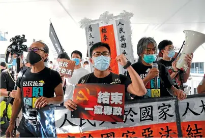  ?? AP ?? Pro-democracy protesters shout slogans in Hong Kong yesterday, after China enacted a national security law that cracks down on protests in the territory.