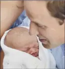  ??  ?? Prince William cuddles his son Prince George Alexander Louis