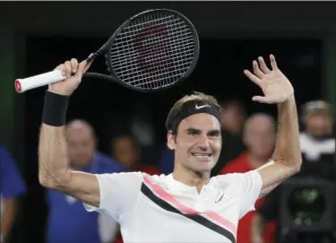  ?? DITA ALANGKARA — THE ASSOCIATED PRESS ?? Roger Federer raises his arms after defeating Marin Cilic in the men’s singles final at the Australian Open Sunday in Melbourne, Australia.