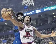  ?? FRANK GUNN/AP ?? Raptors forward OG Anunoby (3) and Magic forward Jonathan Isaac battle for possession of the ball in the first half.