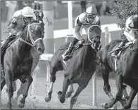  ?? Arkansas Democrat-Gazette/MITCHELL PE MASILUN ?? Inside Straight, ridden by Jockey Geovanni Franco (center), hits the first turn during Saturday’s Oaklawn Handicap. Inside Straight won the 11/8-mile race in 1:48.40 by 2 lengths over Domain’s Rap.