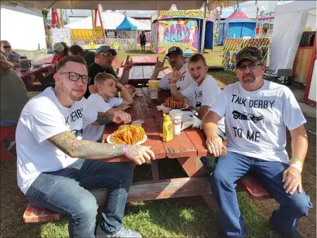  ??  ?? Demolition derby participan­t Brandon Munhall, left, and his family: son Hunter, 7, uncle Jack, son Cameron, 10, and father Ed.