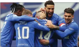  ??  ?? BLUE-EYED BOY: Ryan Kent is mobbed by delighted team-mates after his goal