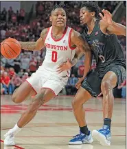  ?? Associated Press ?? Driving: Houston guard Marcus Sasser (0) drives the lane against Memphis guard Elijah McCadden, right, during the second half of an NCAA college basketball game Sunday in Houston.