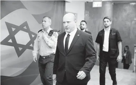  ?? ABIR SULTAN AP ?? Israeli Prime Minister Naftali Bennett (center) attends a cabinet meeting in Jerusalem on Sunday. On Thursday, a second Knesset member quit Bennett’s ruling coalition, raising the prospect of new elections as the government struggles to stay in power.