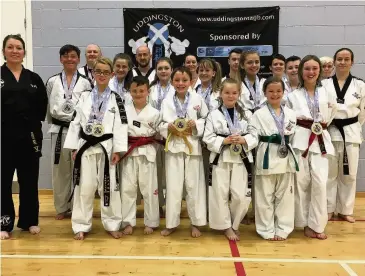  ??  ?? Congratula­tions to TAGB fighters Jonathan Maxwell (back left), Mark Gilluley, Gillian Mcwilliams, Michal Mcgraw, Laura Mclean, Michelle Duffy; Kirsty Izat (middle left), Aiden Carlin, Nicole Gilluley, Mya Munro, Lucy Buchanan, Jodi Smith, Zak Maxwell,...