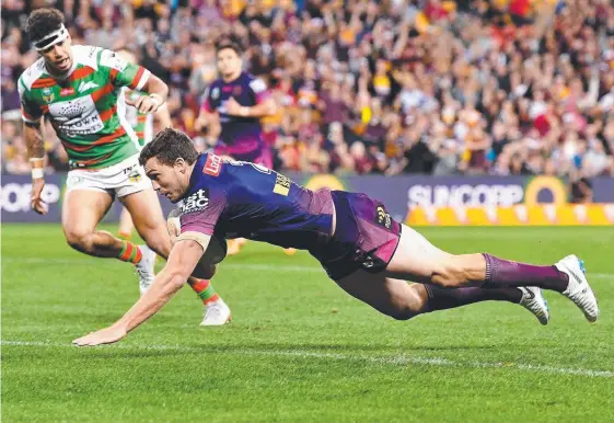  ?? Picture: GETTY IMAGES ?? Brisbane winger Corey Oates scores one of his three tries against the Rabbitohs.