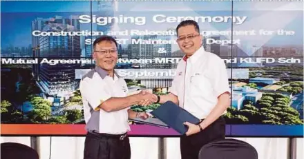  ??  ?? TRX City chief executive officer Datuk Azmar Talib (left) and MRT Corp chief executive officer Datuk Seri Shahril Mokhtar exchanging documents in Kuala Lumpur yesterday.