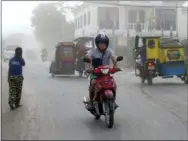  ?? BULLIT MARQUEZ— THE ASSOCIATED PRESS ?? Volcanic ash from Mayon volcano’s eruption partly blanketed Guinobatan township, Albay province, around 340 kilometers (200 miles) southeast of Manila, Philippine­s, Wednesday.