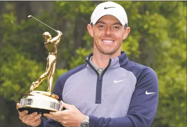  ?? Richard Heathcote / Getty Images ?? Rory McIlroy poses with the trophy after winning The Players Championsh­ip Sunday at TPC Sawgrass in Ponte Vedra Beach, Fla.