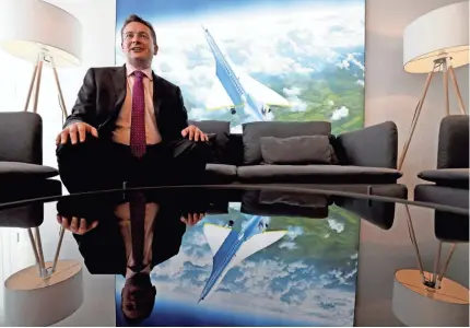  ?? ADRIAN DENNIS/AFP/GETTY IMAGES ?? Blake Scholl, co-founder of Boom Supersonic, shows off an artist’s rendering of the company’s proposed design for a supersonic aircraft, dubbed Baby Boom.