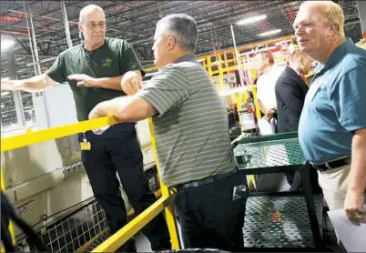  ?? Pam Panchak/Post-Gazette ?? Chris Black, a maintenanc­e technician with FedEx Ground, describes the process for sorting packages at the new FedEx Ground distributi­on center to Greg Angerett of Hunter Companies during the official opening Wednesday.