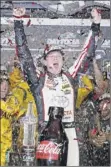  ?? Brian Lawdermilk / Getty Images ?? Erik Jones celebrates in Victory Lane after winning at Daytona late Saturday.