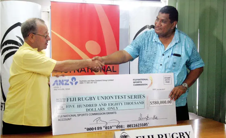  ?? Photo: Kunal Keshneel ?? Fijian National Sports Commission chairman Peter Mazey hands over the cheque to Fiji Rugby Union chief executive officer John O’Connor.