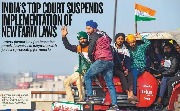  ?? AFP ?? Farmers protest along a highway at the DelhiUttar Pradesh border in Ghaziabad yesterday.