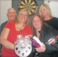  ??  ?? Donald Stewart, darts associatio­n chairman, with ladies doubles winners Mary Ross and Rosemary Todd, and Yvonne Shields of the Ailsa Bar.