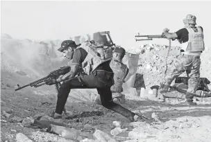  ?? ASSOCIATED PRESS FILE PHOTO ?? Iraqi security forces defend their positions against an Islamic State group attack near Ramadi in 2015. Though the group was defeated and lost the territory it controlled, its sleeper cells remain years later.