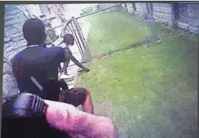  ?? MILWAUKEE POLICE ?? In a still image from a police officer body camera, Officer Dominique Heaggan-Brown points his weapon at Sylville Smith as Smith reaches for the gun that he dropped during a chase.