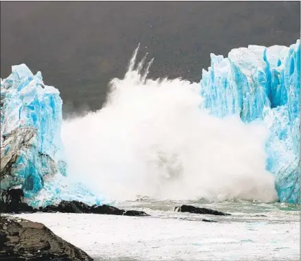  ?? Walter Diaz AFP / Getty Images ?? AN ICE BRIDGE comes crashing down in the Perito Moreno Glacier in Argentina’s Andes mountain range in March 2016.