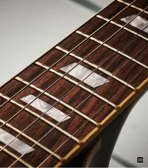  ??  ?? 10 10. You can see the slightly thicker fingerboar­d binding here with characteri­stic fret-end ‘nibs’ and single parallelog­ram markers in pearloid. Frets are medium jumbo and the Indian rosewood ’board is beautifull­y grained