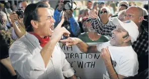  ?? Picture: GETTY IMAGES ?? FOR AND AGAINST: Florida resident Peter Bell, left, who supports the new policy by US President Barack Obama, argues with people who say the shock new policy to try to end hostilitie­s is a betrayal and that talks will only benefit Cuba. They are...