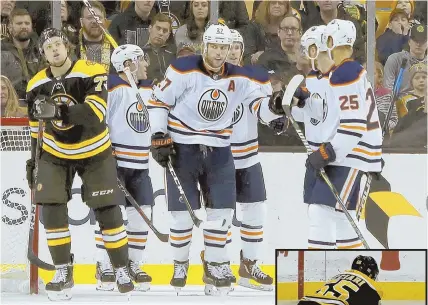  ?? AP PHOTOS ?? FRUSTRATIN­G DAY: Milan Lucic (27) celebrates with teammates while Charlie McAvoy (73) skates back up the ice during the Bruins' 4-2 loss to the Edmonton Oilers yesterday at the Garden. At right, the B's Noel Acciari buries Leon Draisaitl with a big hit.