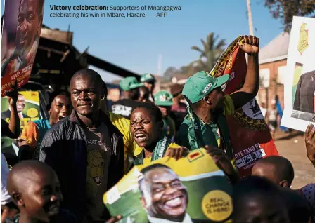  ?? — AFP ?? Victory celebratio­n: Supporters of Mnangagwa celebratin­g his win in Mbare, Harare.