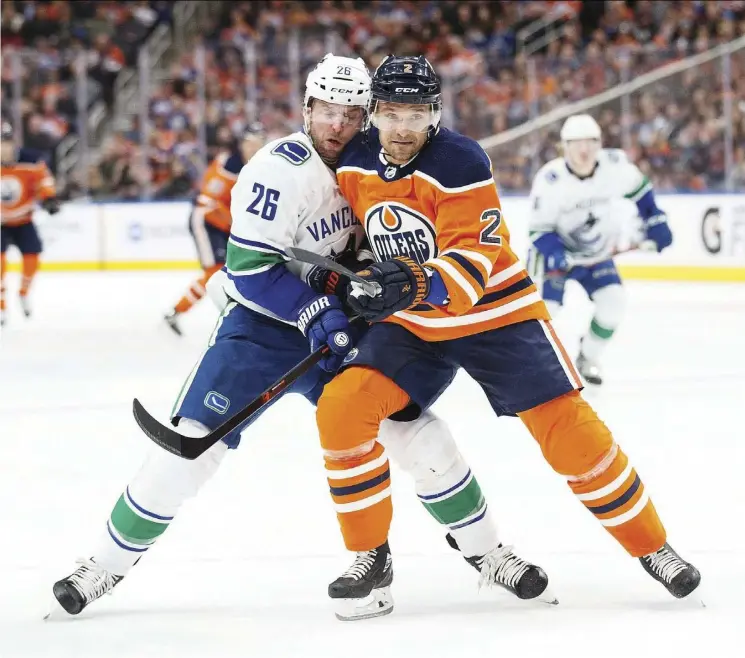  ?? Getty ImaGes/FIles ?? Edmonton’s Andrej Sekera battles Thomas Vanek of the Canucks at Rogers Place in January of 2018. Sekera is two games into a conditioni­ng stint at Bakersfiel­d.