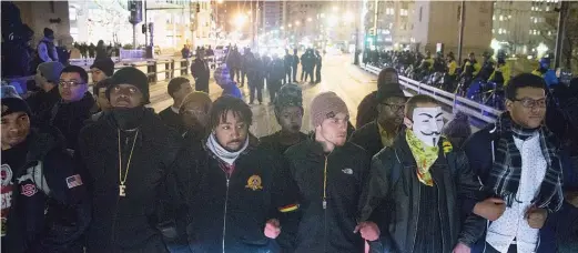  ?? SCOTT OLSON/GETTY IMAGES ?? Small and mostly peaceful protests sprouted up around the city the day after the release of a video showing Chicago Police Officer Jason Van Dyke shooting and killing Laquan McDonald. Above, demonstrat­ors block traffic on the Michigan Avenue bridge on Nov. 25, 2015.