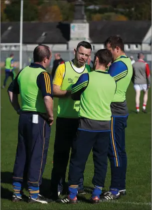  ??  ?? Carnew manager James Hickey in discussion with his selectors during last Sunday’s IFC final.