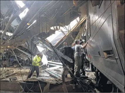  ?? PANCHO BERNASCONI / GETTY IMAGES ?? Train personnel survey the New Jersey Transit train that crashed into the platform in Hoboken on Thursday. “The train didn’t stop. It just didn’t stop,” said one witness.