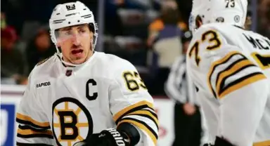  ?? ROSS D. FRANKLIN/ASSOCIATED PRESS ?? Brad Marchand (left) and Charlie McAvoy picked up the physical play for the Bruins.