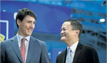  ?? CHRISTOPHE­R KATSAROV/ THE CANADIAN PRESS ?? Prime Minister Justin Trudeau tours the market place with Alibaba Group founder Jack Ma at the Gateway Conference in Toronto on Monday.