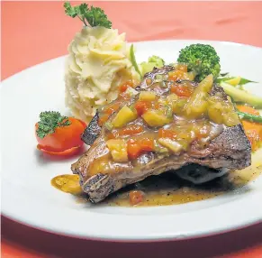  ??  ?? Grilled teriyaki pork chops, tender and juicy, topped with a pineapplep­apaya relish.