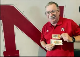  ?? ERIC OLSON — THE ASSOCIATED PRESS ?? John Fey shows off his ticket stubs from Nebraska’s 1971“Game of the Century” against Oklahoma and the Cornhusker­s’ 1984Orange Bowl against Miami.