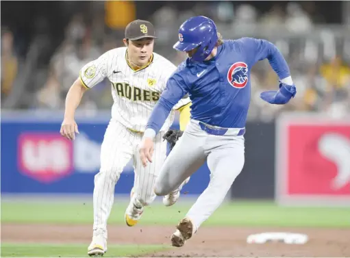  ?? DENIS POROY/AP ?? The Cubs’ Nico Hoerner (shown being tagged out Monday against the Padres) had 43 stolen bases last season but entered play Friday with none this season.