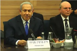  ?? (Marc Israel Sellem/The Jerusalem Post) ?? PRIME MINISTER Benjamin Netanyahu, with National Security Council head Meir Ben Shabbat, attends the Foreign Affairs and Defense Committee at the Knesset yesterday. According to a Channel 2 report, Ben Shabbat visited on Sunday with National Religious leader Rabbi Haim Druckman, who then spoke with Bayit Yehudi head Naftali Bennett, convincing him to stay in the coalition.