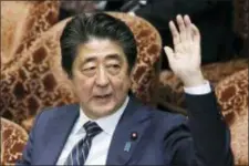  ?? KYODO NEWS VIA AP ?? Japanese Prime Minister Shinzo Abe raises his hand during a parliament­ary session at the Lower House in Tokyo, Monday.