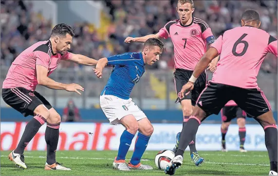  ?? Picture: PA ?? SURROUNDED: Emanuele Giaccherin­i finds himself the centre of attention in Malta last night as the Scots toiled to contain the impressive Italians.