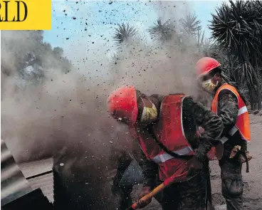  ?? JOHAN ORDONEZ / AFP / GETTY IMAGES ?? Guatemalan army members search for victims in the village of San Miguel Los Lotes, following the eruption of the Volcano of Fire. Workers pulled more bodies from under the dust and rubble Tuesday, bringing the death toll to 69.