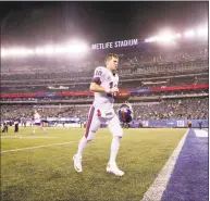  ?? Julio Cortez / Associated Press ?? Giants quarterbac­k Eli Manning leaves the field after a 34-13 loss to the Philadelph­ia Eagles on Thursday night.