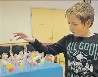  ?? ASHLEY THOMPSON ?? Liam Kozera of Berwick contemplat­es his best move at the sucker pull station set up for Berwick’s winter carnival fun day.