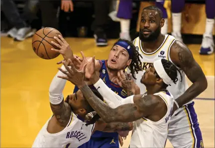  ?? AARON ONTIVEROZ — THE DENVER POST ?? Aaron Gordon, center, of the Nuggets vies for a rebound against D’angelo Russell, left,, Jarred Vanderbilt, right, and Lebron James, top, of the Lakers during the third quarter of Game 3at Crypto.com Arena in Los Angeles on Saturday.