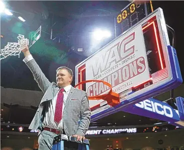  ?? STEVE MARCUS/ASSOCIATED PRESS FILE ?? New Mexico State coach Chris Jans, shown after cutting down the net after the Aggies won the Western Athletic Conference basketball tournament in 2019, will face new challenges in league play in 2022.