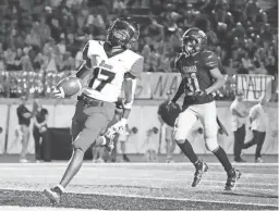  ?? ROB SCHUMACHER/THE REPUBLIC ?? Liberty wide receiver Jaqua Anderson scores a touchdown past Saguaro safety Angel Thues on Friday.