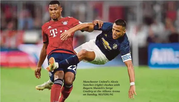  ?? REUTERS PIC ?? Manchester United’s Alexis Sanchez (right) clashes with Bayern Munich’s Serge Gnabry at the Allianz Arena on Sunday.